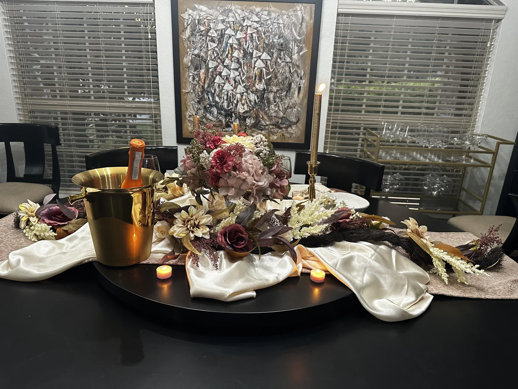 Luxury floral centerpiece with champagne and candlelight for a private dinner