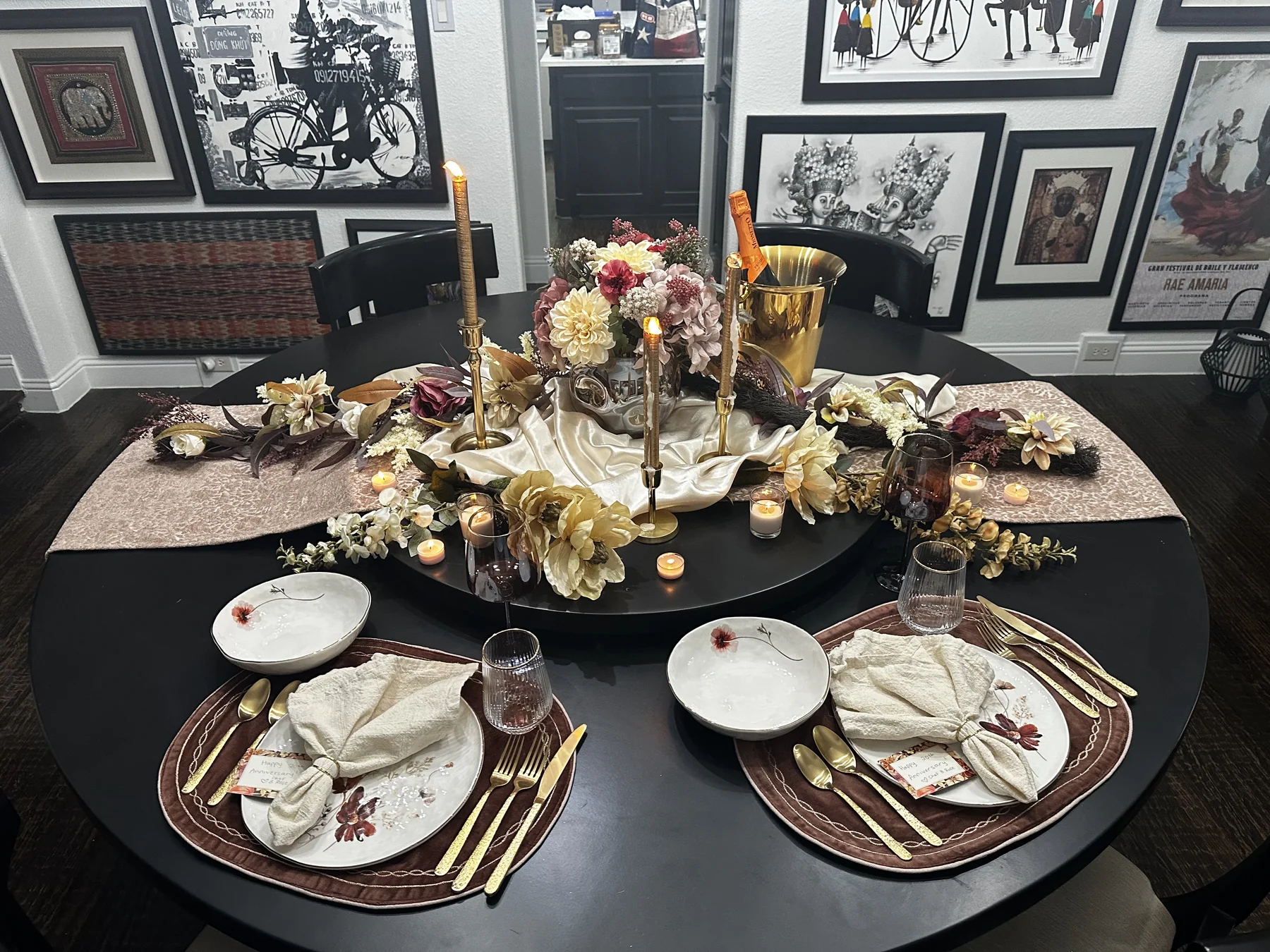 Candlelit in-home dinner table for two with champagne and floral decor